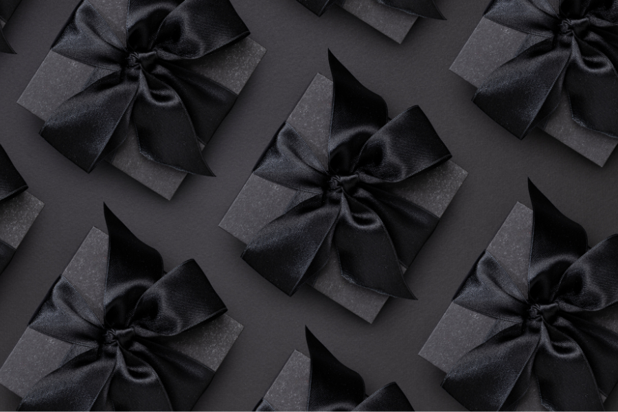 Black presents with bow on black background