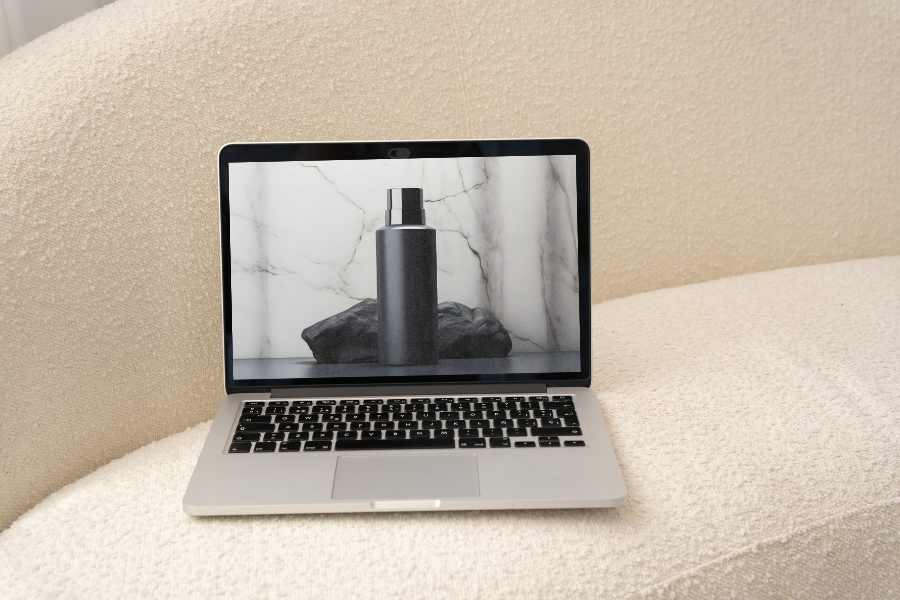 Laptop with website design on cream sofa